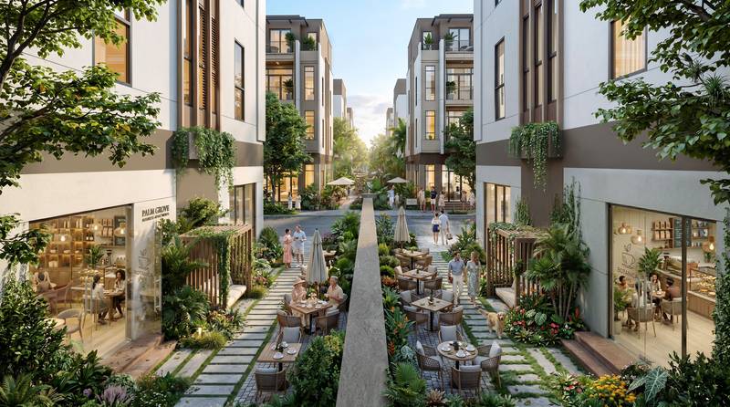 Lối đi bộ xẻ khe giữa hai dãy nhà phố Global Park, có bàn café và cây xanh, tại Vinhomes Saigon Park